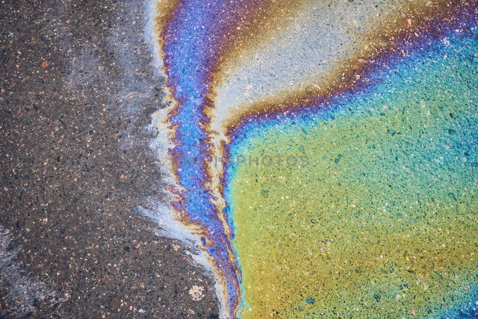 A slick of leaked fuel or oil on the asphalt by AliaksandrFilimonau