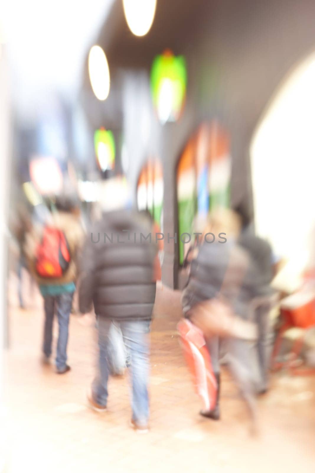 Blurred, city and crowd on street outdoor in London for population migration at night with light. Busy people, motion or walking on road for travel, journey or commute in urban society with buildings by YuriArcurs