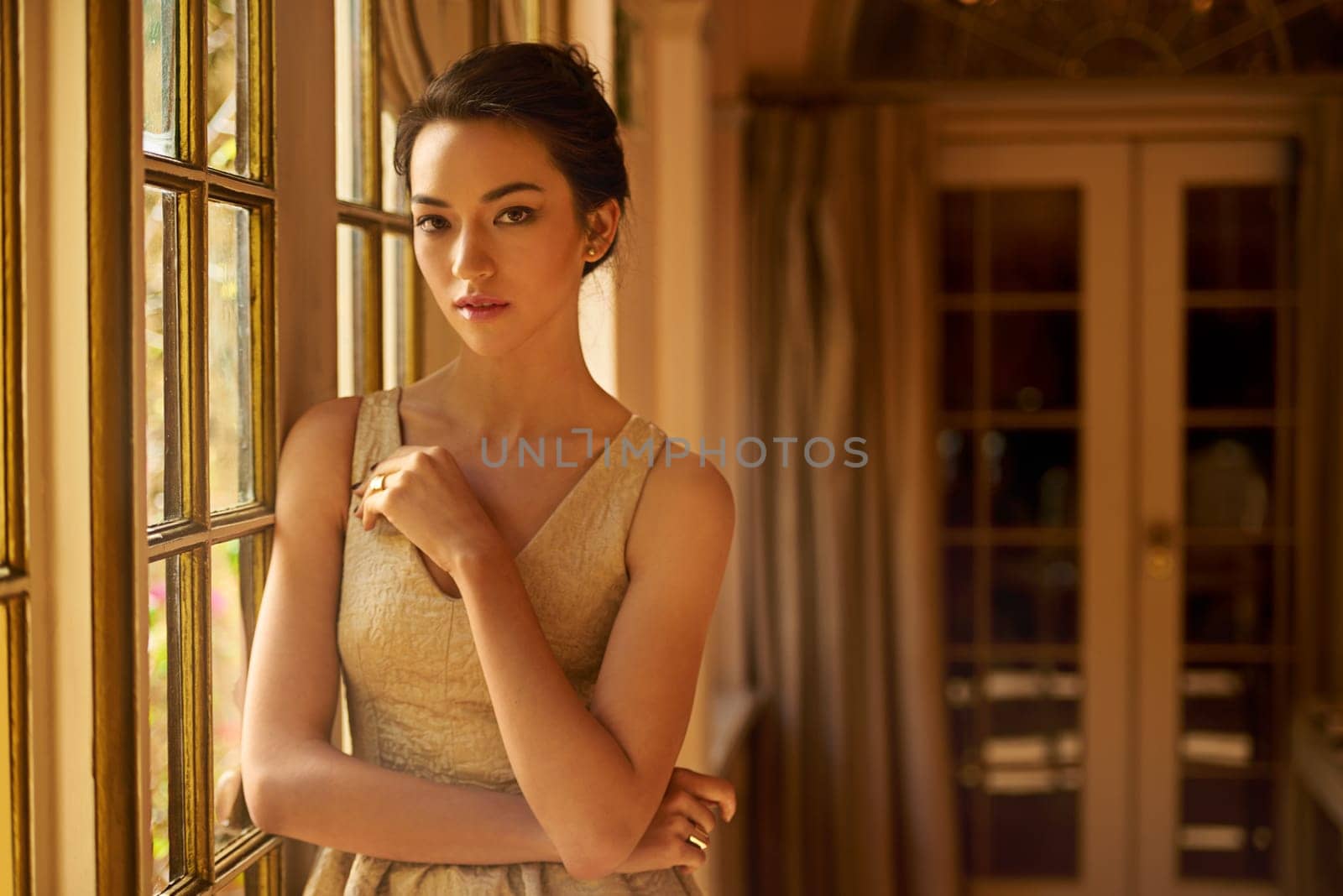 Fashion, window and portrait of elegant woman in home for gala event in style, classy outfit and dress. Wealth, aesthetic and person with confidence, pride and glow in vintage manor, house or mansion by YuriArcurs