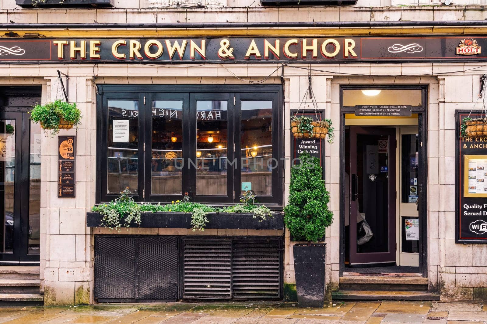 Manchester, UK - February 20 2020: The Crown and Anchor pub facade with house-brand ales and comfort food, operated by the Joseph Holt Brewery.