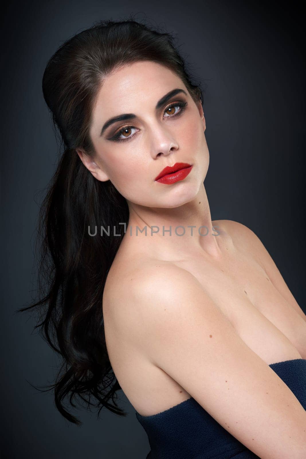 Beauty, woman and makeup portrait with goth, retro and classic cosmetics in a studio. Glamour, Old Hollywood and black background with red lips, dark eyeshadow and confidence with elegant fashion by YuriArcurs