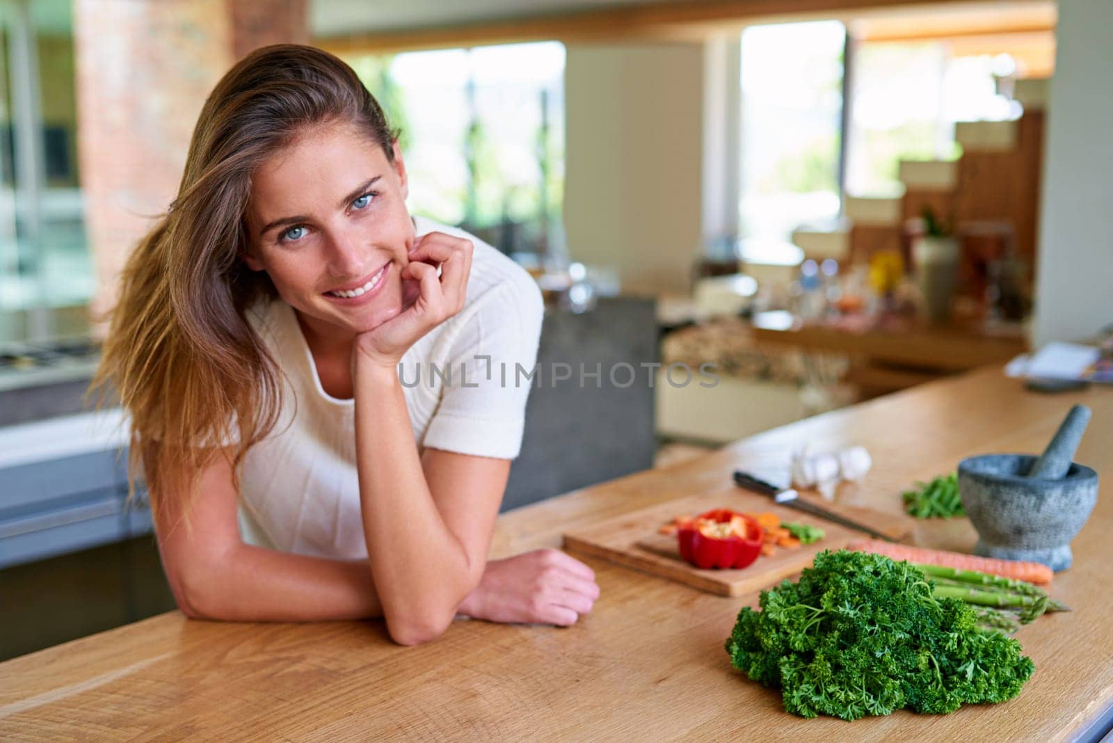 Portrait, kitchen and woman with vegetables, smile and organic ingredients with vegan, healthy meal and diet. Nutrition, vegetarian and person in home, food and chef with skills, cooking and wellness.