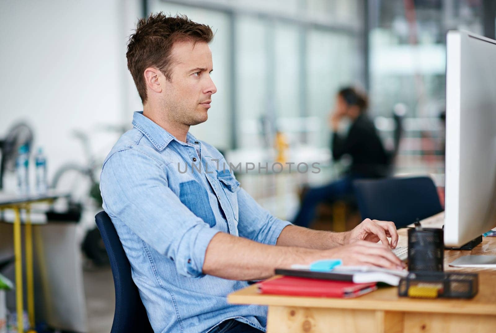 Man, office and computer with online research for creativity, designs and ideas for project as graphic designer. Employee, working and desktop in desk in startup business or agency with deadline.