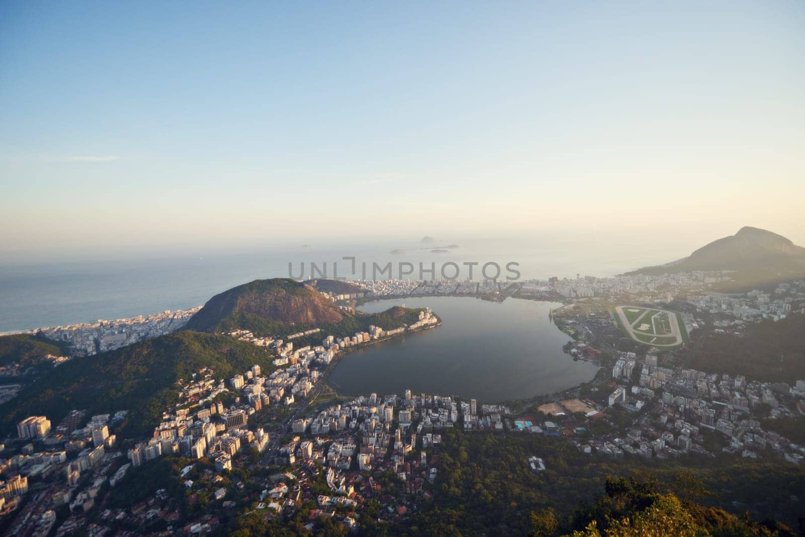 City, ocean and blue sky with vacation, drone and Rio De Janeiro for summer holiday, urban town and aerial view. Landscape, location and beach with buildings, getaway trip and mountains with sunshine by YuriArcurs