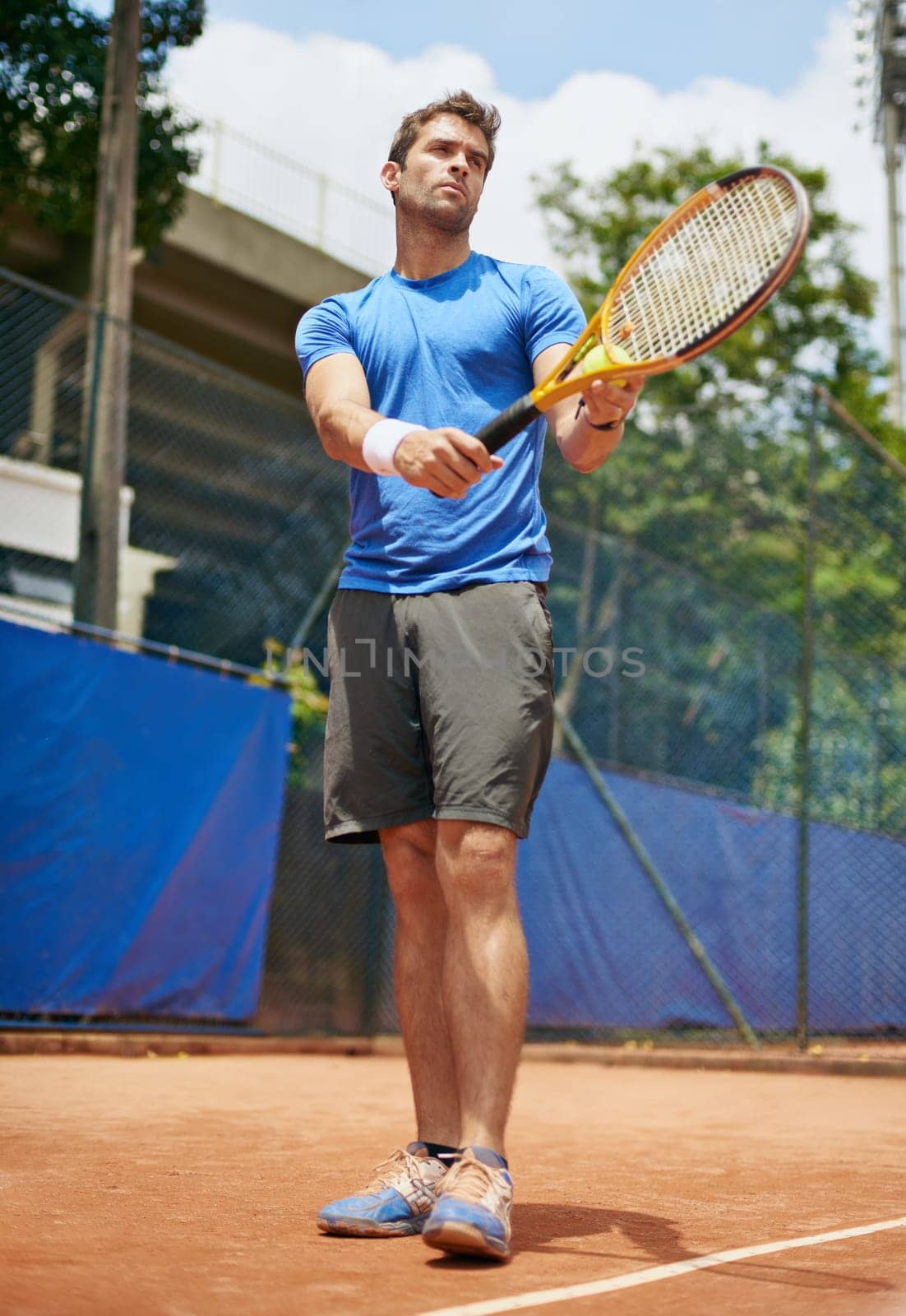 Man, confident and serve in outdoor tennis match, game and court for competition or practice. Male person, athlete and ready for training or exercise, workout and hobby for action and play fitness.