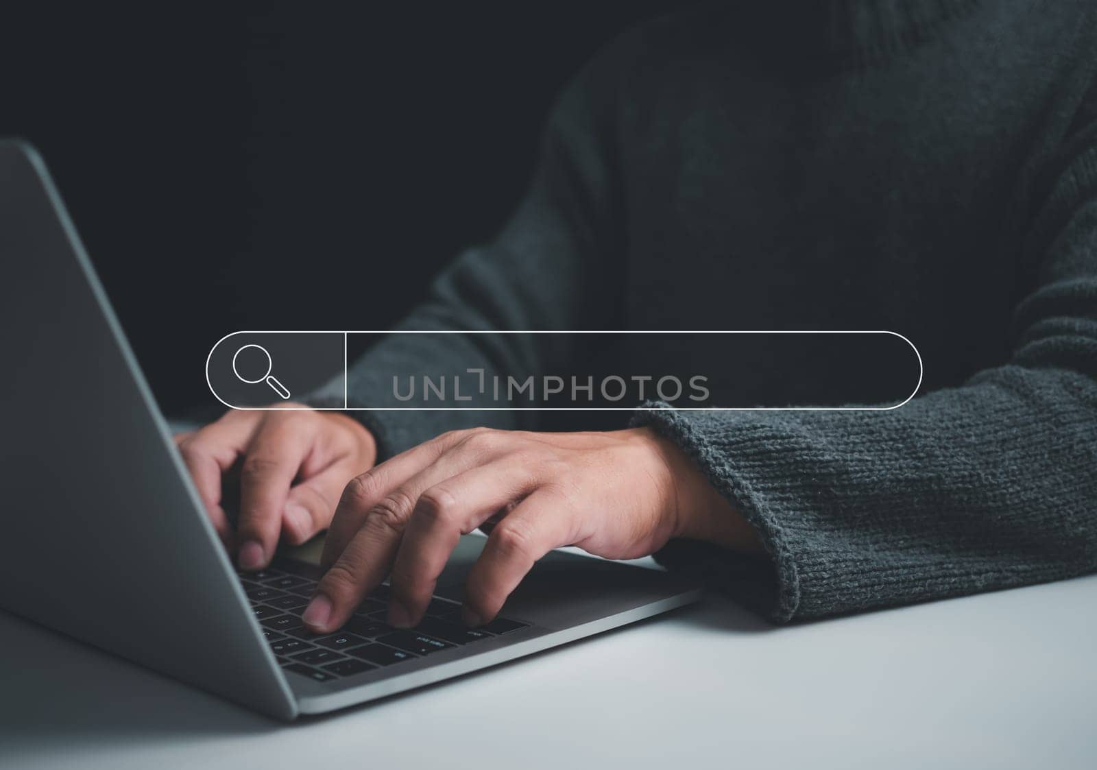 Human hand working on computer and search icon. The concept of searching for information from the internet network.  by Unimages2527