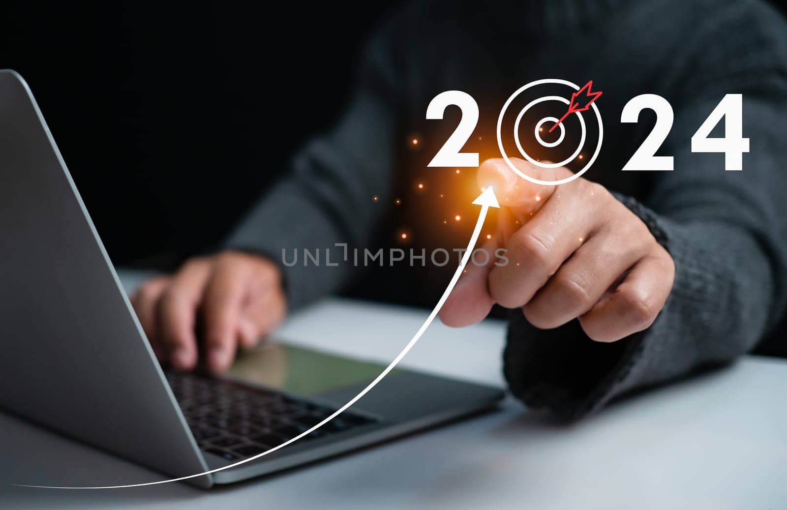 Businessman pointing at dart board icon Represents the goal setting for 2024, concept of startup, financial planning, development strategy, business goal setting.