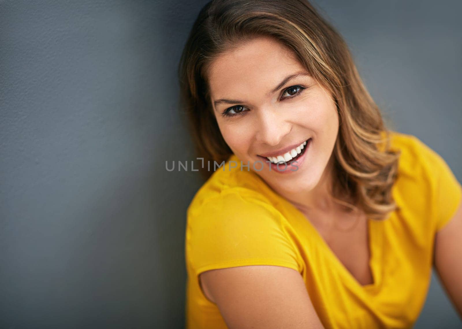 Wall, morning and portrait of woman, rest and relax for with smile, Gen z and streetwear for fashion in house. Grey background, happiness and girl in apartment, cheerful and comfortable in home by YuriArcurs