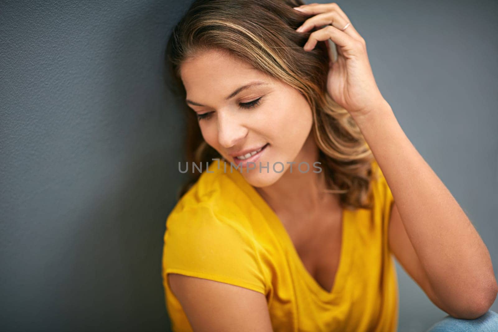 Wall, smile and woman on floor, relax and rest for weekend, Gen z and streetwear for fashion in house. Grey background, clothes and girl in apartment, cheerful and comfortable on ground of home.