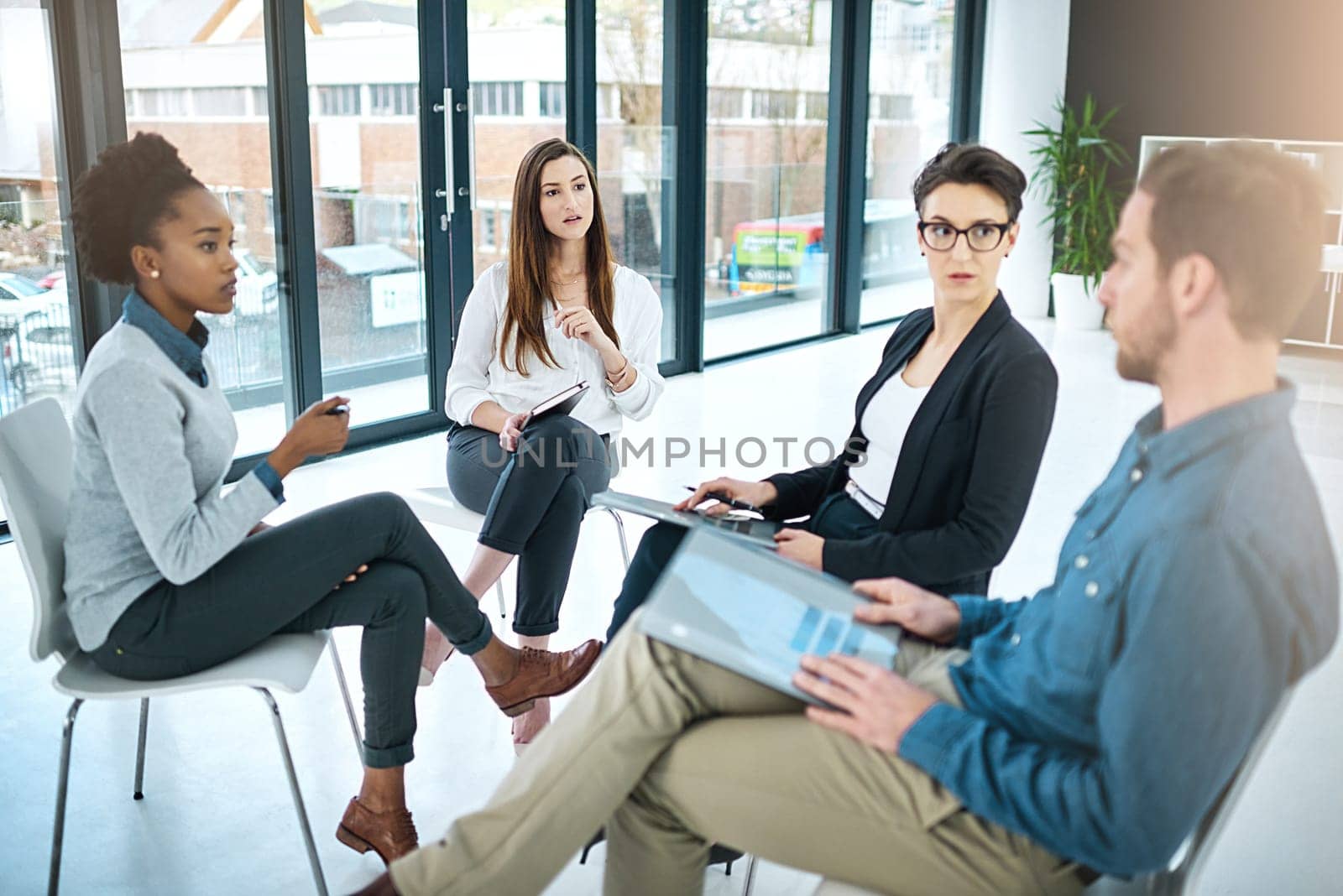 Business people, documents and meeting in office for brainstorming, collaboration and conversation. Coworkers talking or communication in workplace for teamwork, report and reading proposal together.