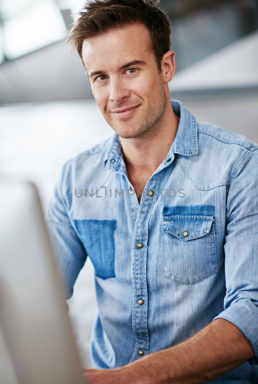 Portrait, creative and business man in office startup, company or workplace for career in Switzerland. Professional, entrepreneur and face of confident employee, worker or editor on computer at job.