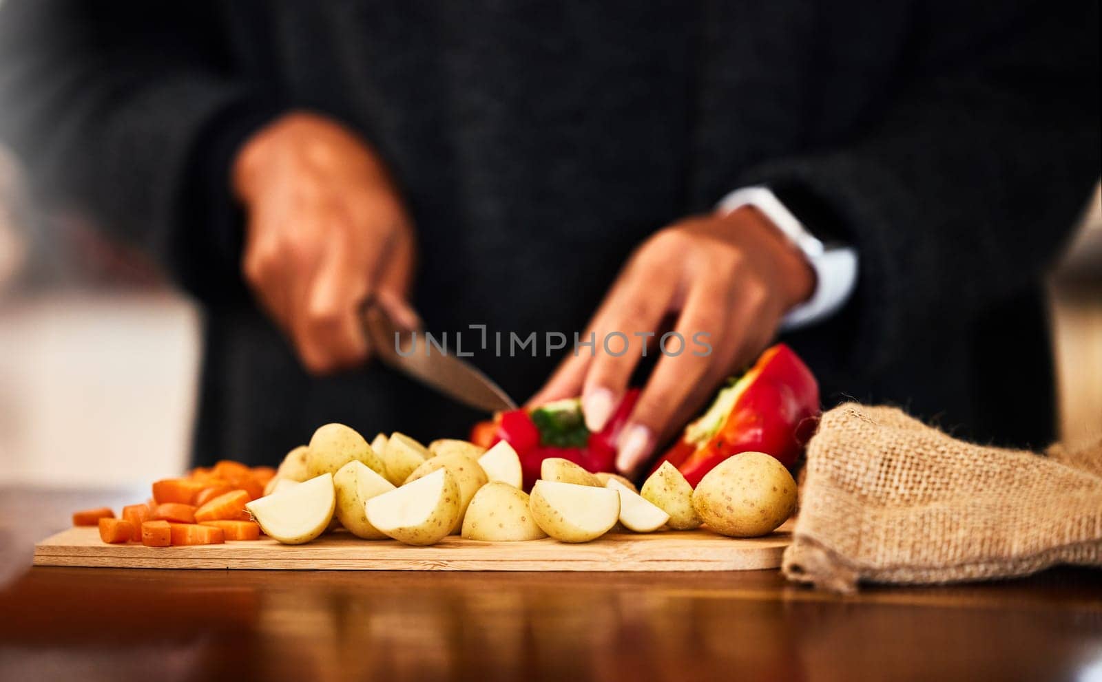 Hands, vegetables and knife on board for prepare in home with raw ingredients with kitchen chef, food and health. Cooking, dinner and person for lunch with eating for nutrition with organic diet.