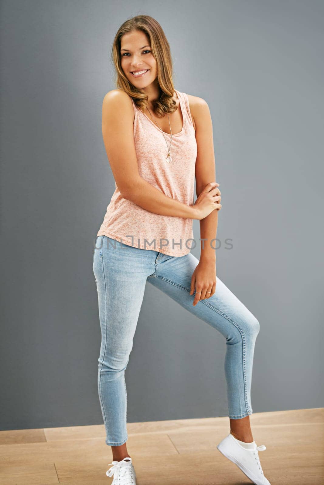 Fashion, smile and portrait of woman on gray wall background for trendy, stylish clothing and confident. Cool, aesthetic and female model for happiness, cheerful or chic outfit on mockup space.