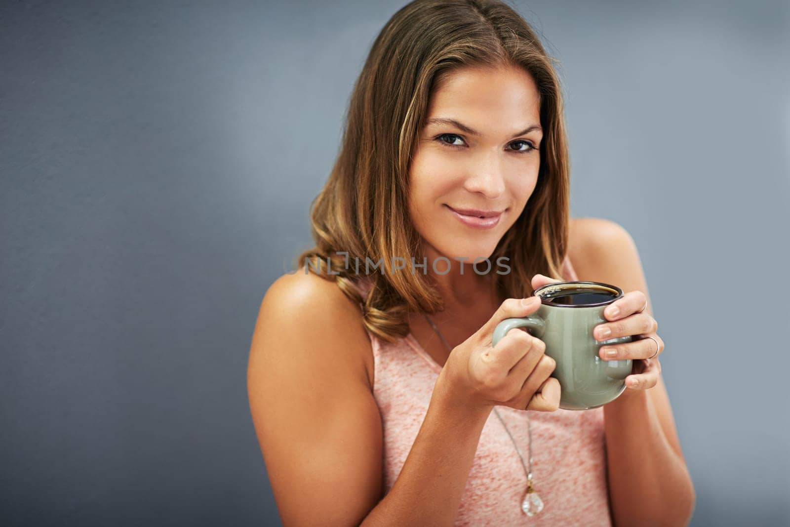Portrait, gray wall and woman with coffee for happiness, break and calm morning. Mug, cappuccino and female person outside drinking hot beverage for relax, peace or to start day on dark backdrop.