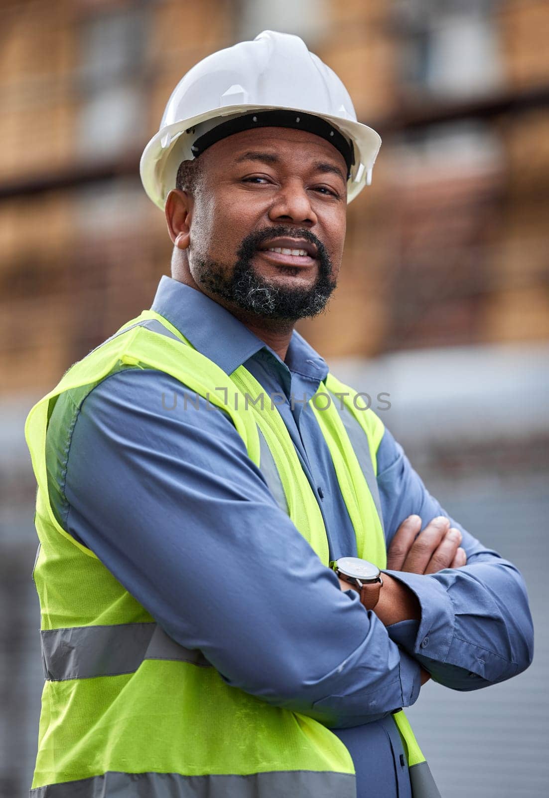 Portrait, confident and male person as contractor outdoors for developing or planning of construction projects. Professional, architect and industry for safety with arms crossed for development.