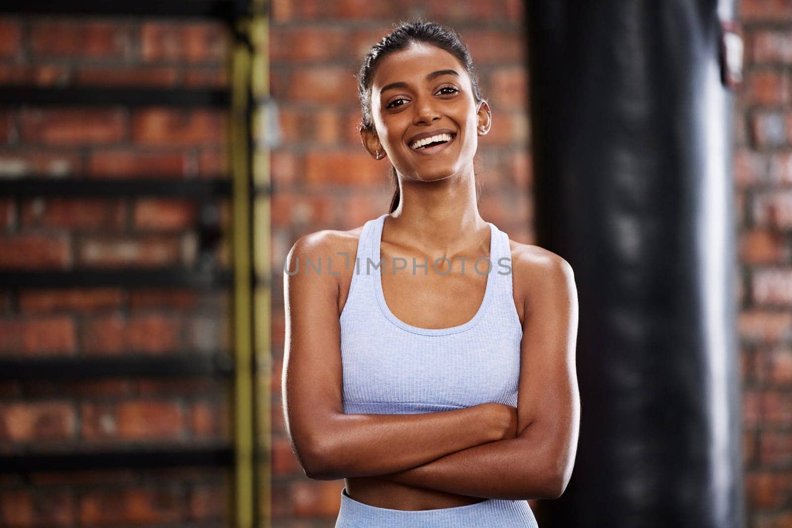 Woman, fitness and portrait in gym for exercise, cardio training and wellness for activity. Indian lady, smile and confident for workout, muscle and sports for health for wellbeing for female athlete by YuriArcurs
