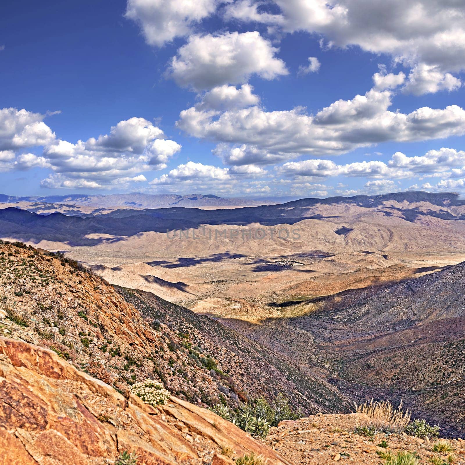 Blue sky, clouds and mountains with landscape for travel, scenery and hiking trail in environment. Sustainable, agriculture and plants on rocks in eco friendly and natural habitat in countryside