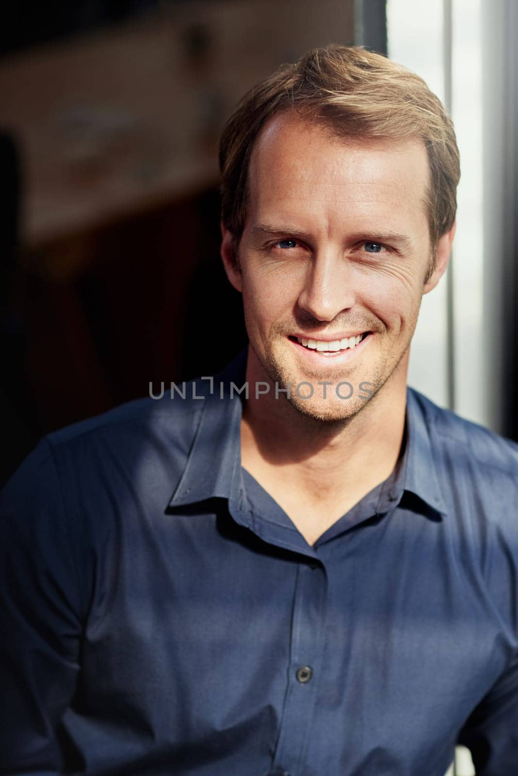 Mature business man, portrait and office by window with smile, confidence and pride at insurance company. Professional person, agent or happy employee in workplace for corporate career in Munich.