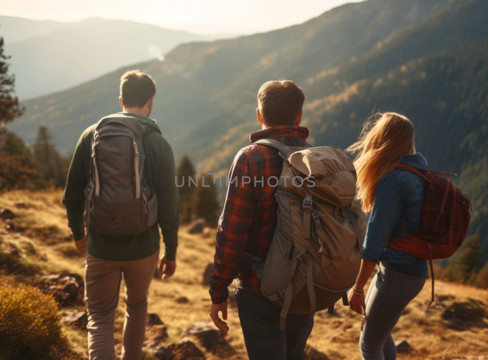 A group of three hikers journeying along a mountain trail, with a stunning view of the valley unfolding below them
