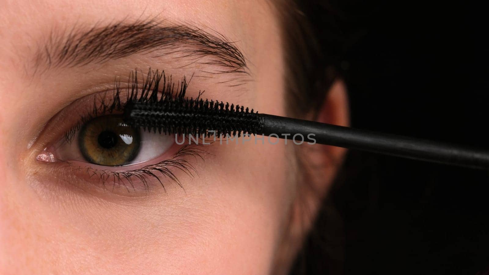 Young Girl Making Makeup Applies Black Mascara On Her Eyelashes, Professional Master Class, Close-Up by GekaSkr