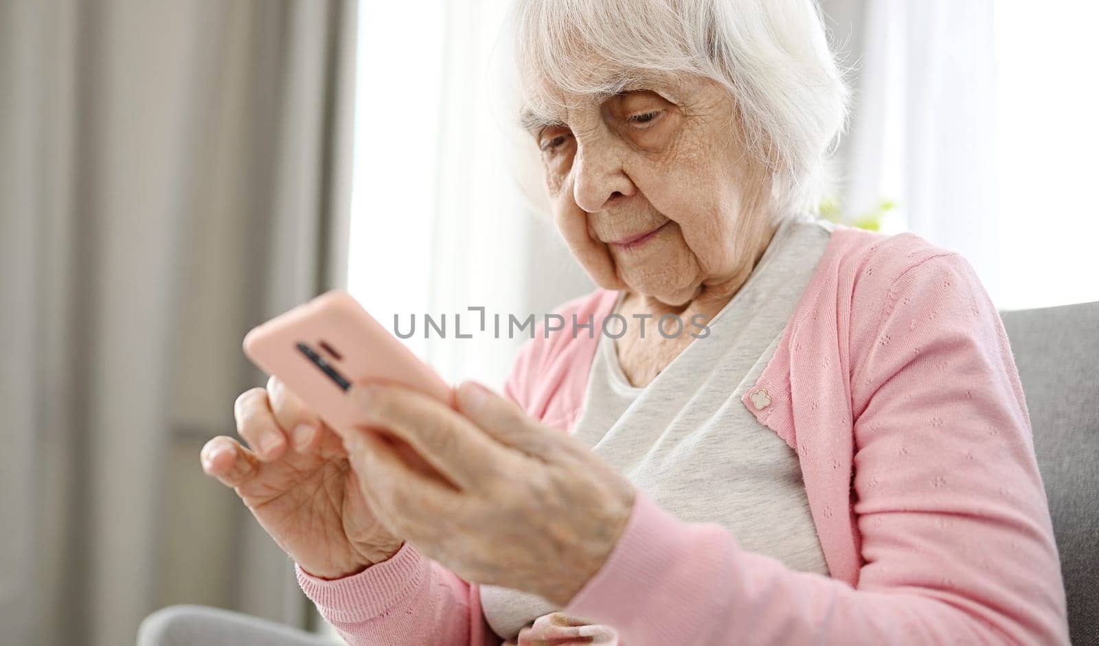 Elderly Woman Using Smartphone Reading Internet News, Close Up View