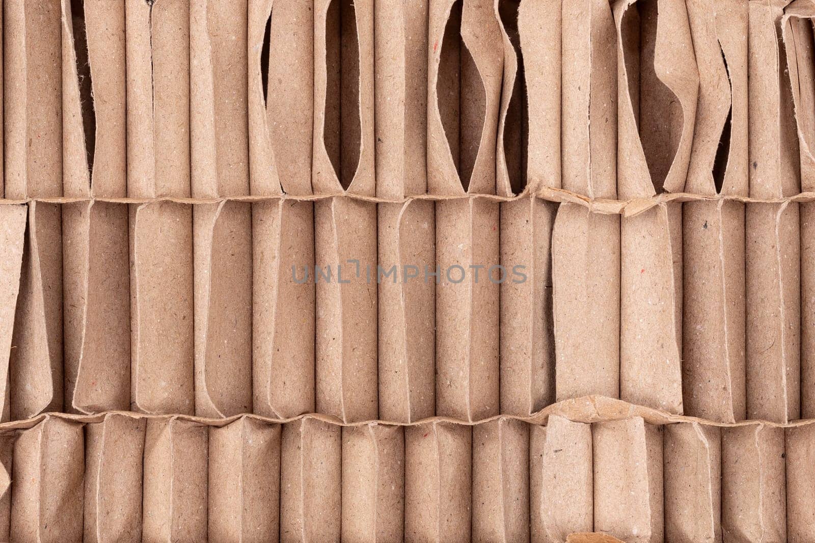 Abstract background of folded brown cardboard texture