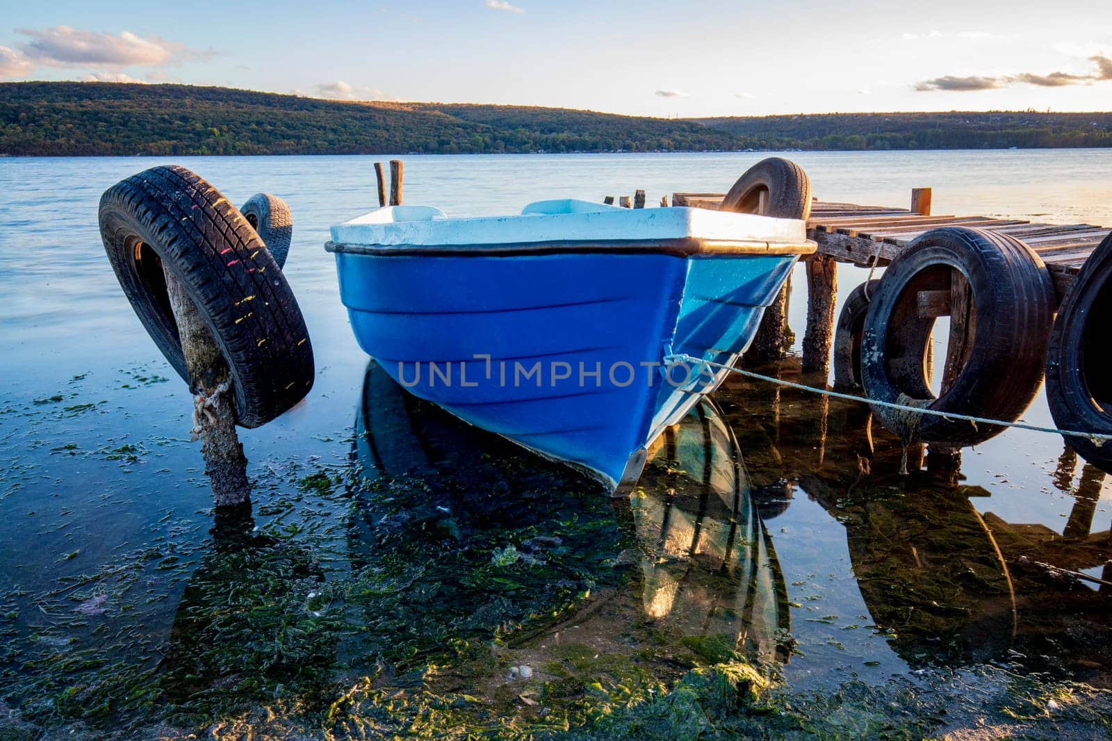 Close up view of a fishing boat at the wooden pier  by EdVal