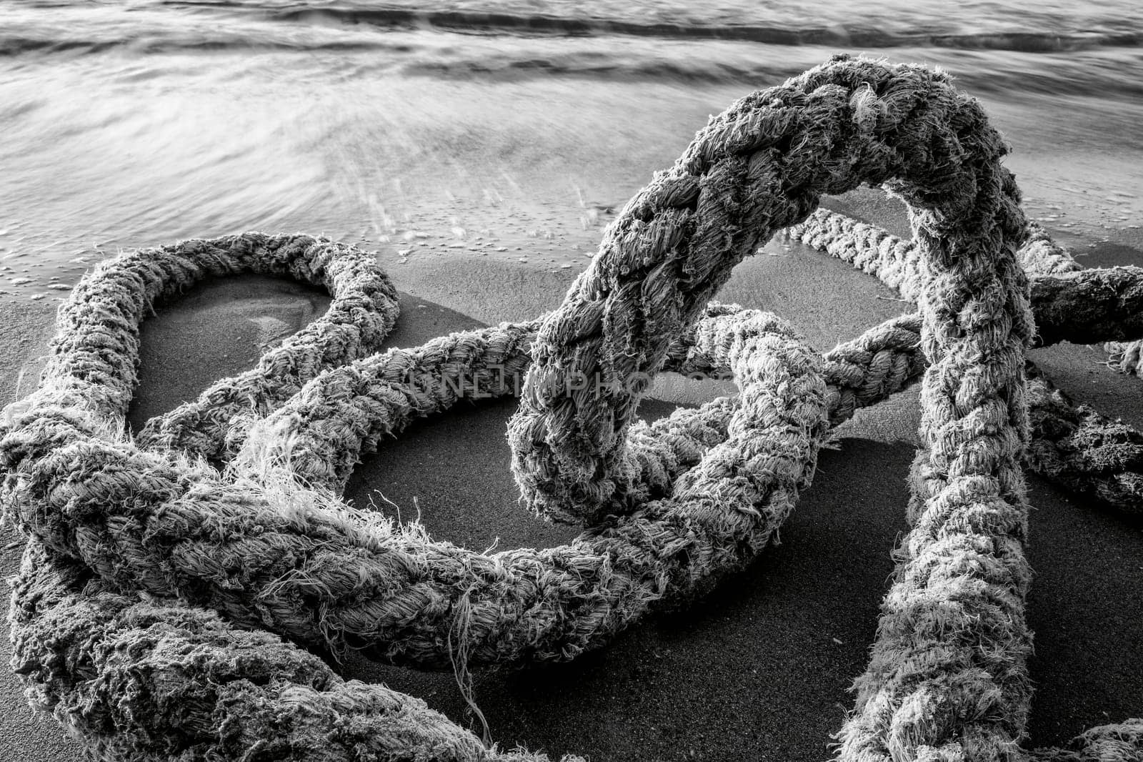 Old boat rope on the beach. Close up by EdVal