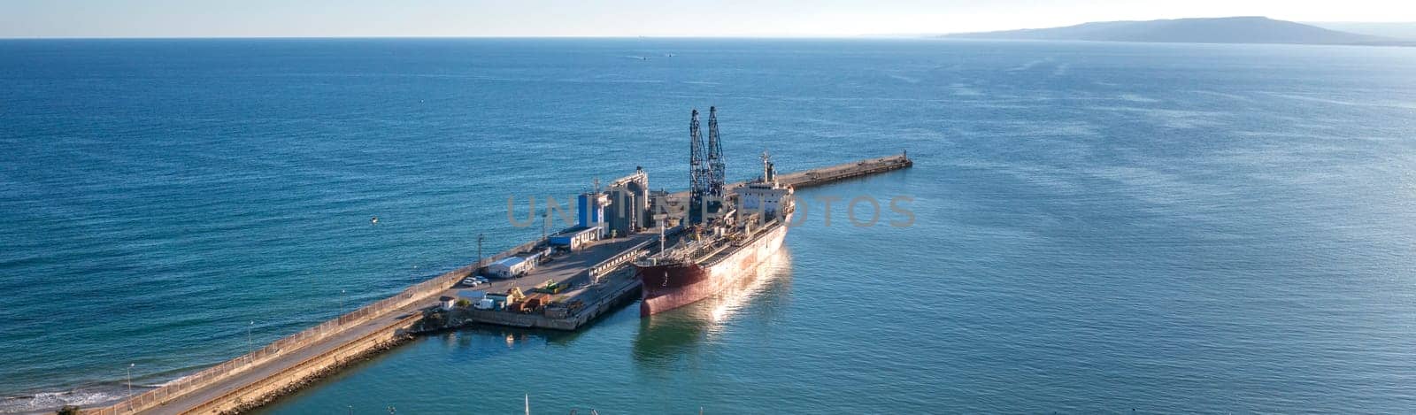 Ship of the industrial port. panoramic view from a drone. Concept export or import 
