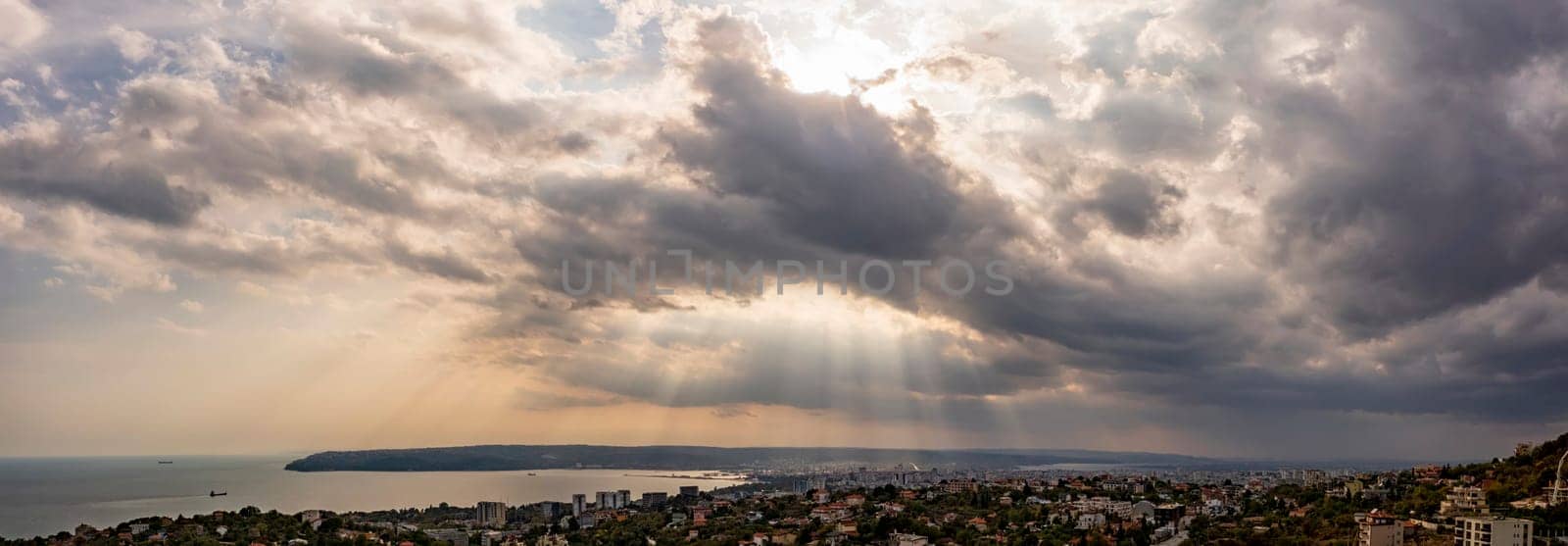 Dramatic clouds and sun rays in the sky over the city