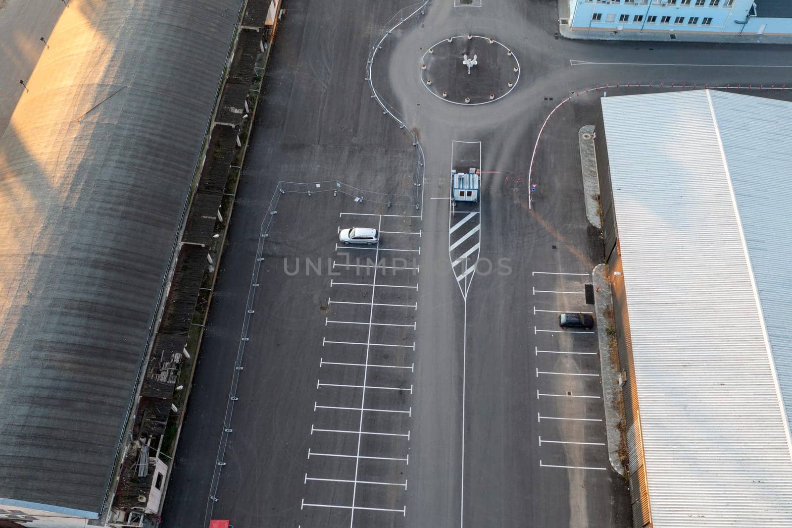 Abstract aerial view from a drone of circle junction road and car parking by EdVal