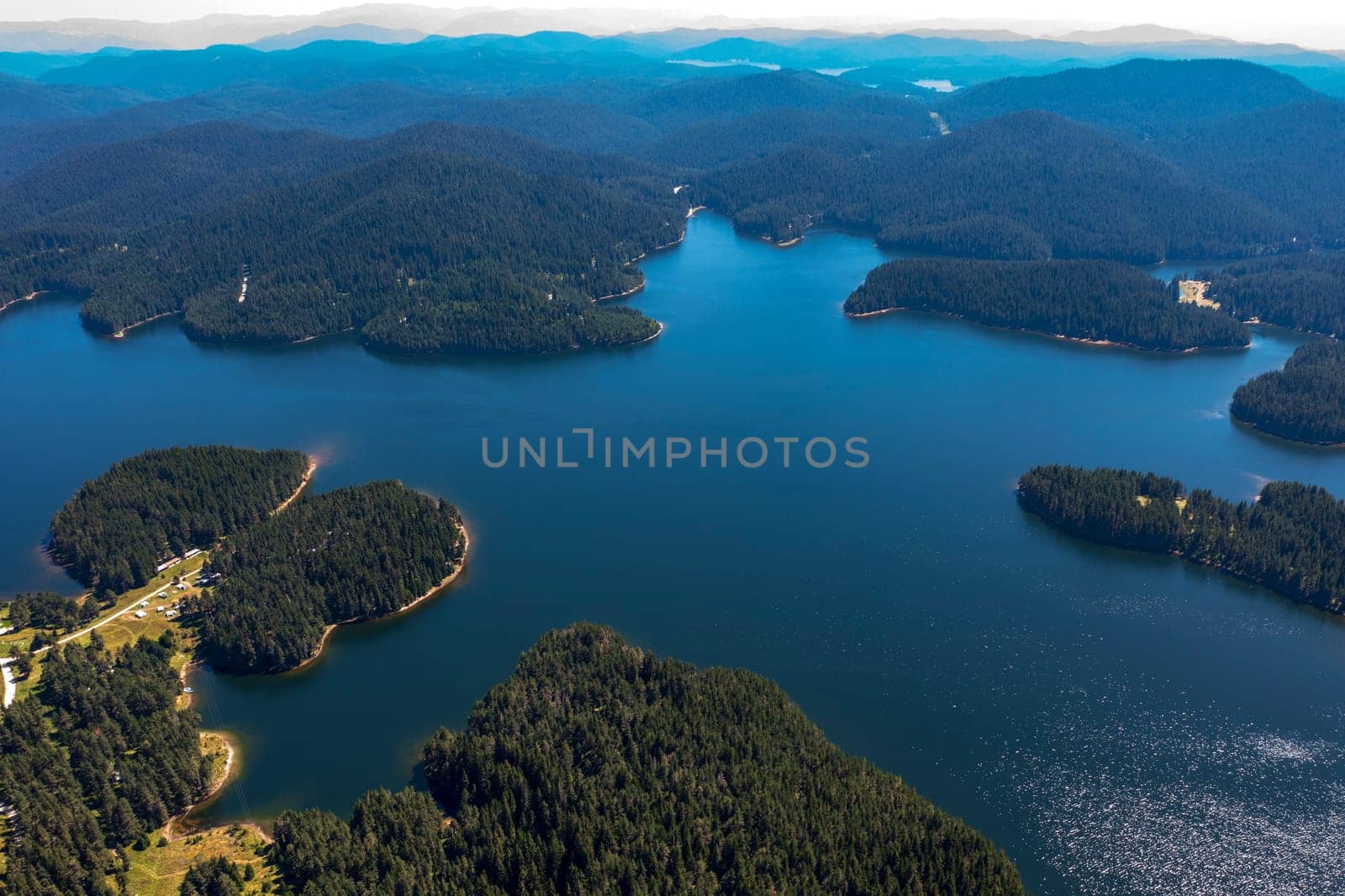 Stunning aerial view at Dam Shiroka Poliana, Bulgaria,  Beautiful blue water and green forest.