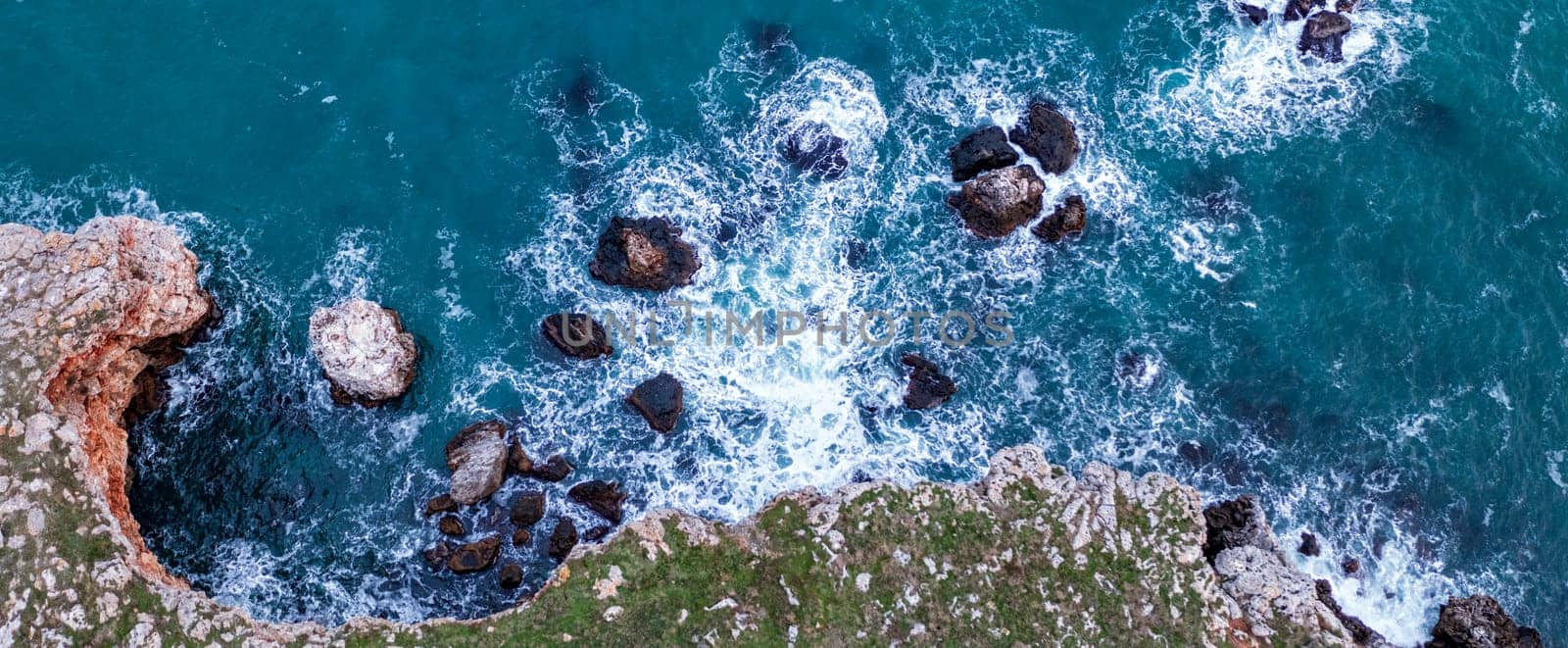 Aerial panoramic view of many rocks near the shore by EdVal
