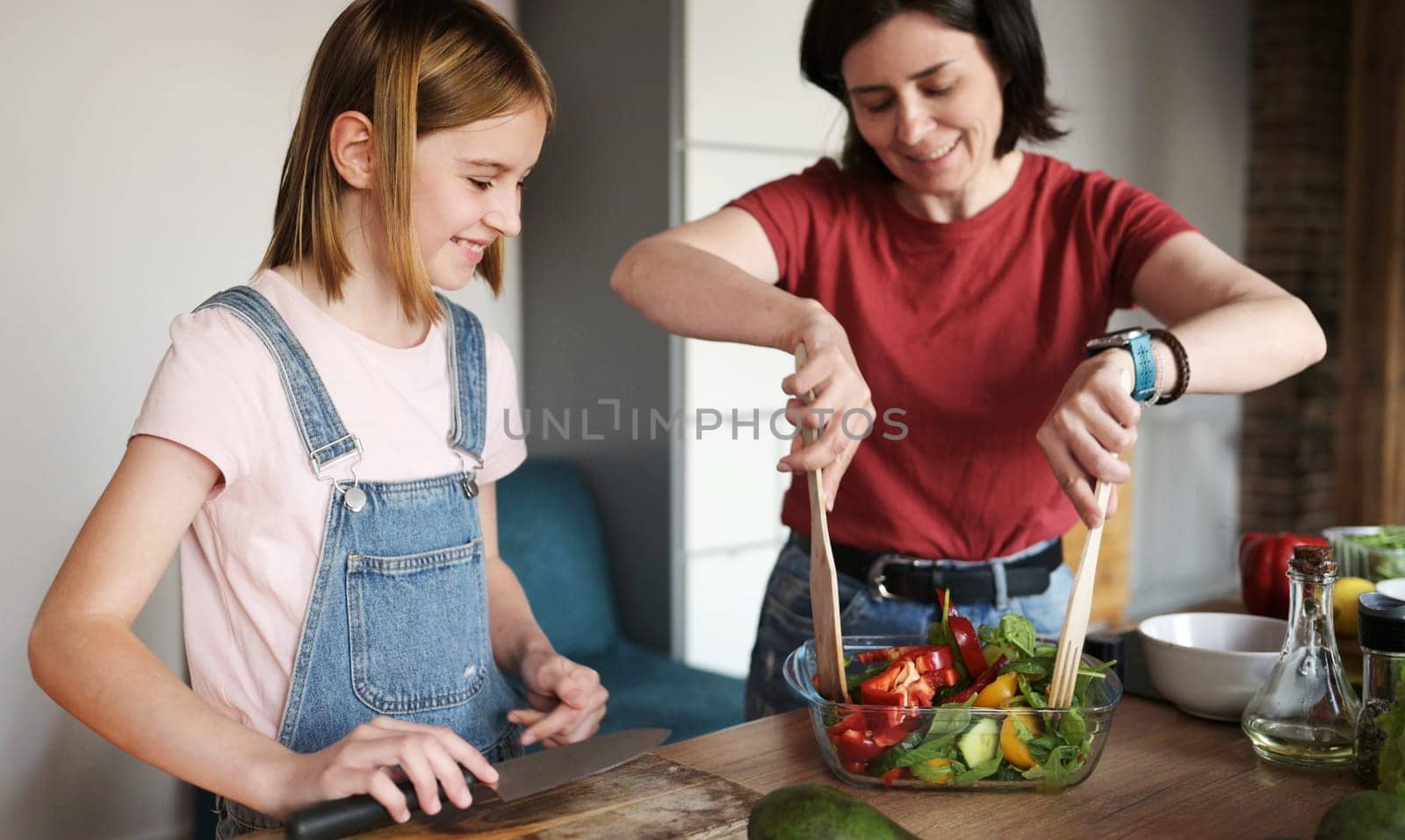 Beautiful Little Girl With Her Mother Cooking A Healthy Fresh Vegetable Salad by GekaSkr