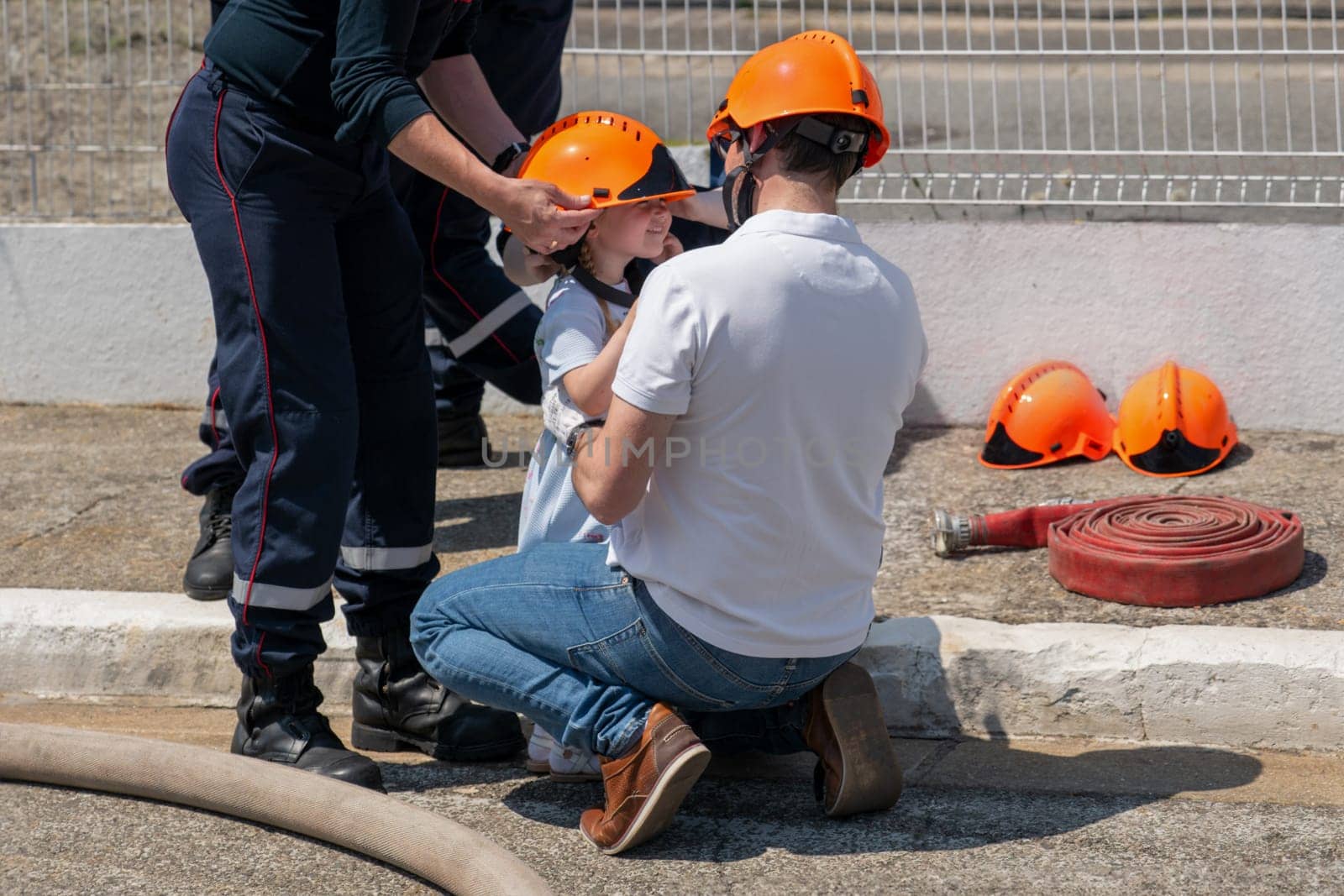 Father teaches his daughter Firefighter training outdoor by Godi