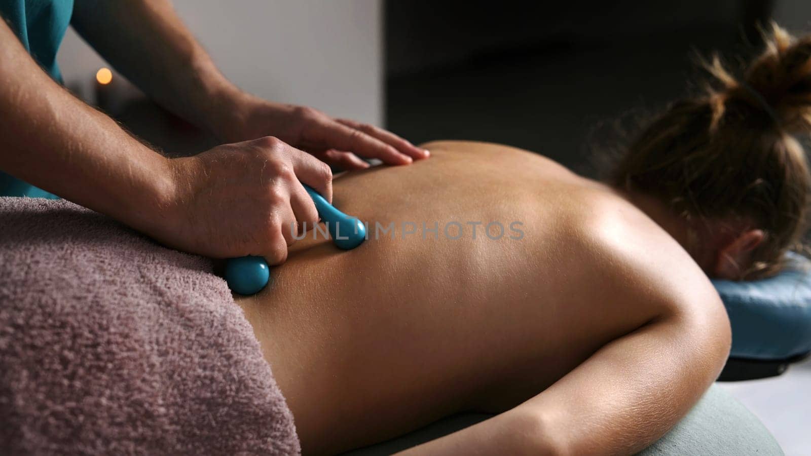 Professional Massage Therapist Doing Back Massage For Young Girl With A Massager In A Spa Salon, Healthy Spine And Back Muscles Procedures