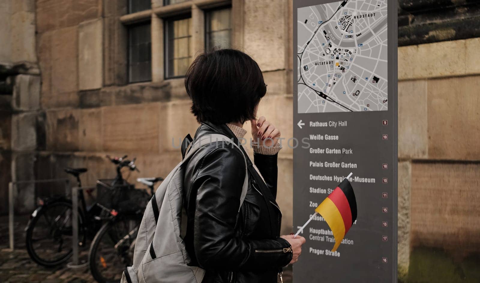 Beautiful Woman Tourist Strolls With German Flag In Dresden'S Historical Center by GekaSkr