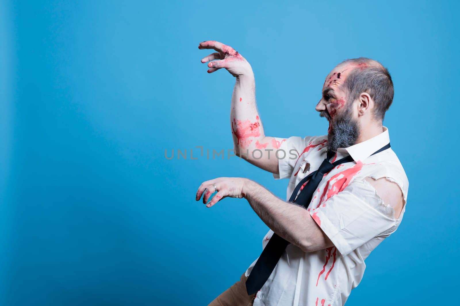Walking dead cadaver searching for flesh to consume, studio background by DCStudio