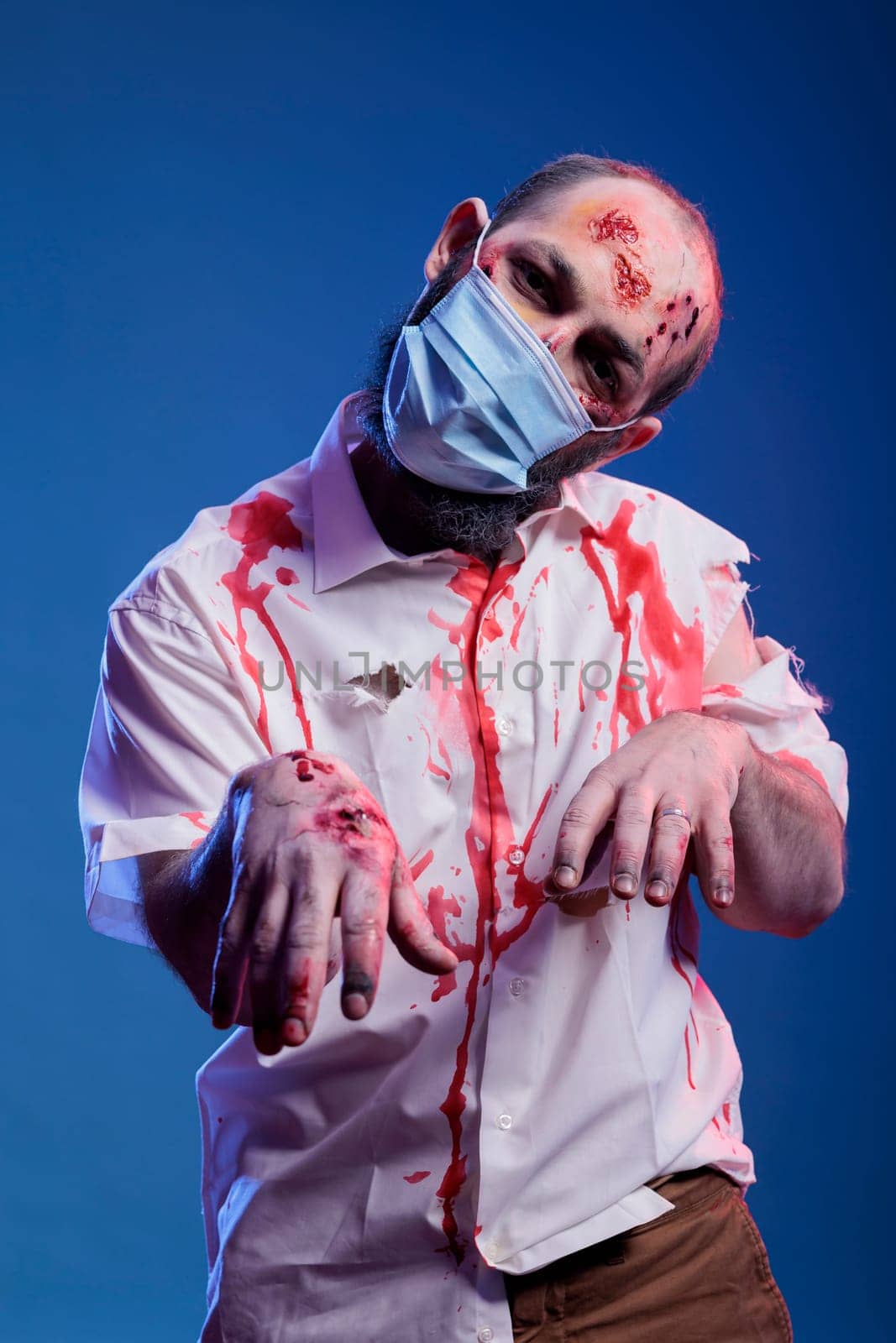 Actor with face mask playing reanimated zombie for thriller film, infected by DCStudio
