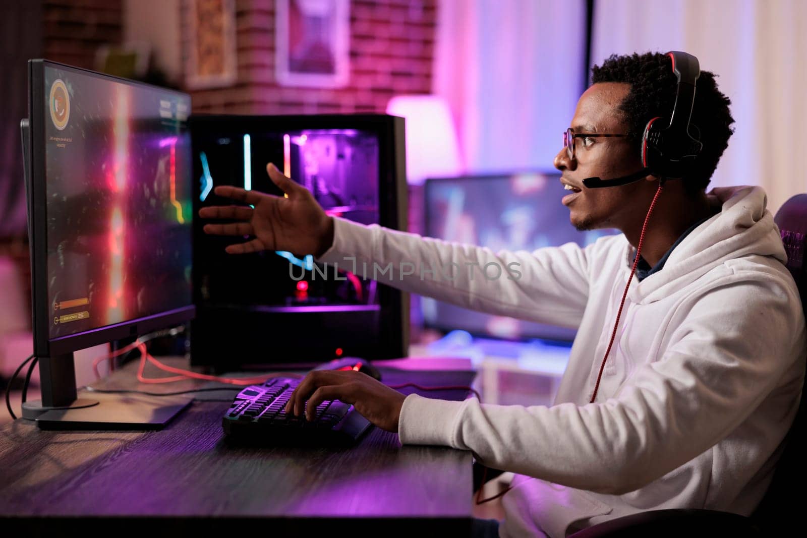Frustrated gamer losing online multiplayer spaceship arcade racing videogame on powerful gaming PC. African american man shocked to see he is outskilled by more capable players