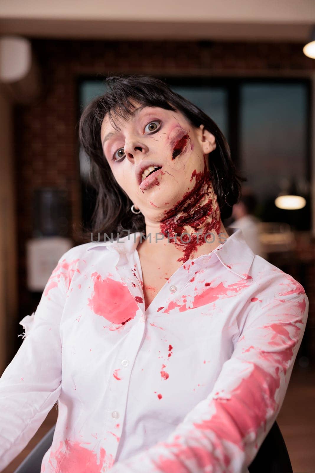 Portrait of fatigued woman at desk becoming undead creature after being worked to death. Businesswoman covered in blood turned into zombie, metaphor for relentless pressure of slave capitalism