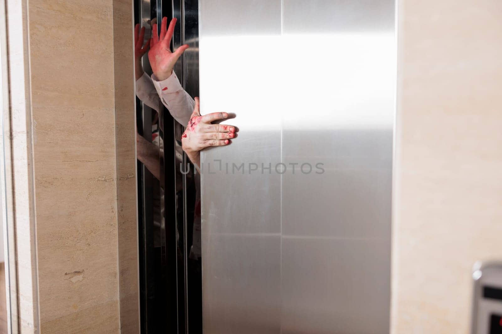 Demonic zombies hands opening office elevator, coming out to infect more people and eat brains during apocalypse. Terrifying bloody cadavers escaping escalator during doomsday