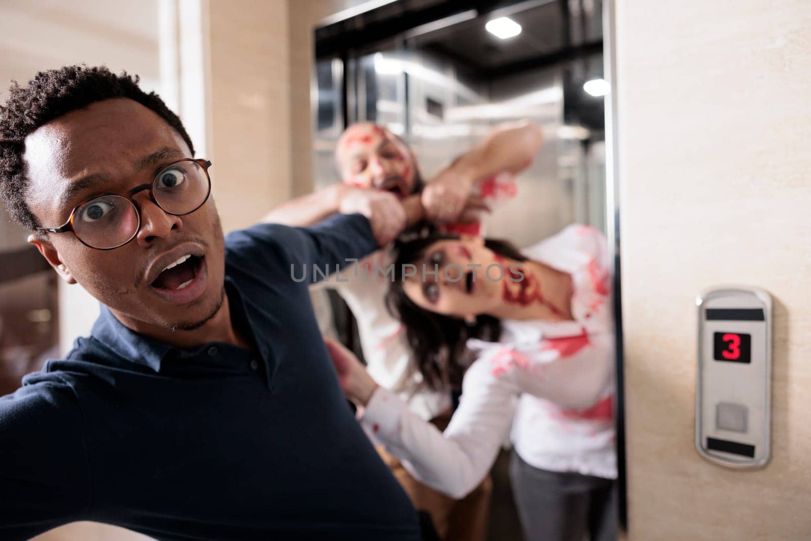 Close up of african american businessman grabbed by scary undead monsters coming out of elevator. Apocalypse survivor chased by brain eating creepy evil zombies in office building