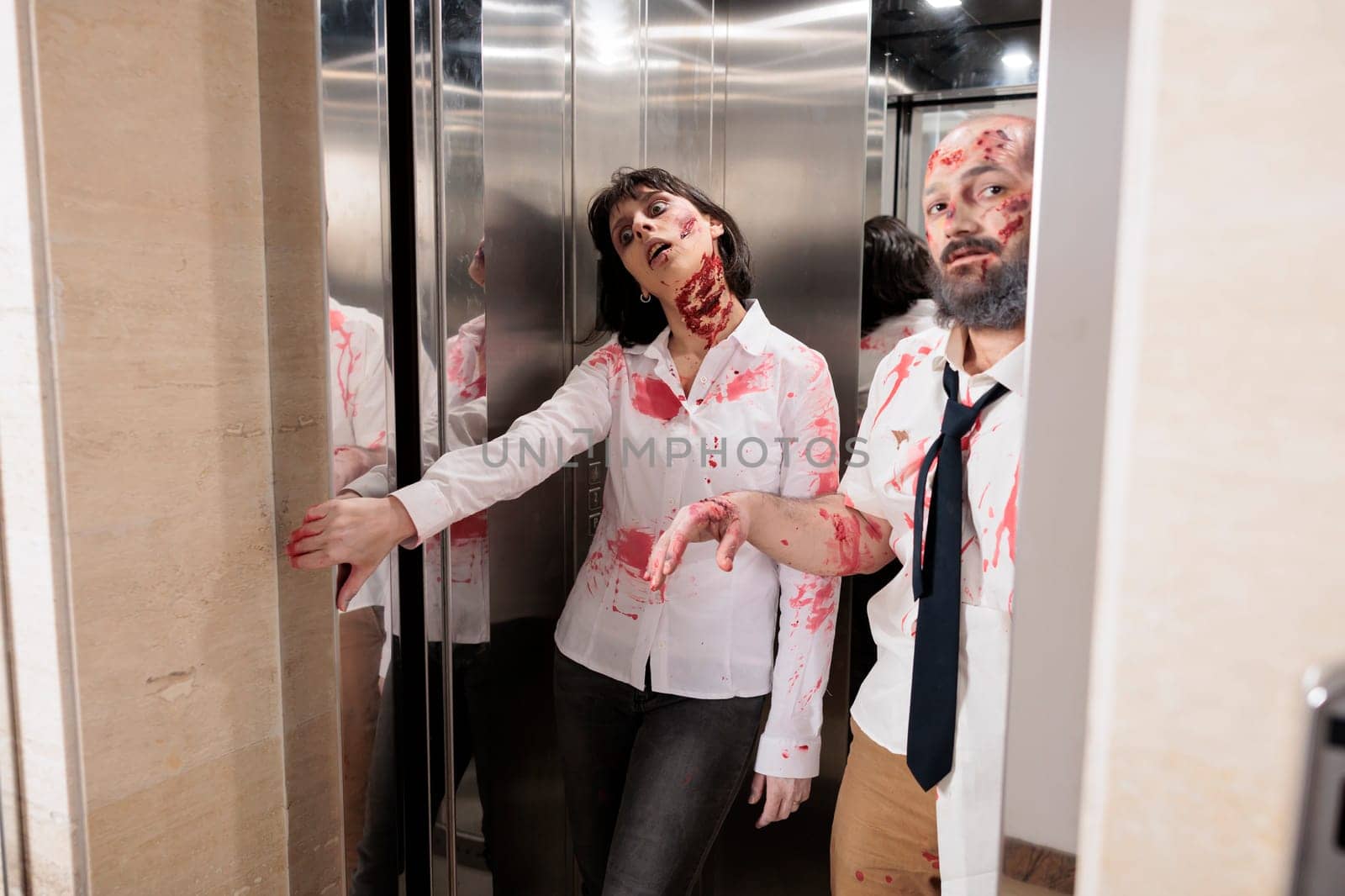 Colleagues covered in fake scars pretending to be zombies exiting escalator by DCStudio