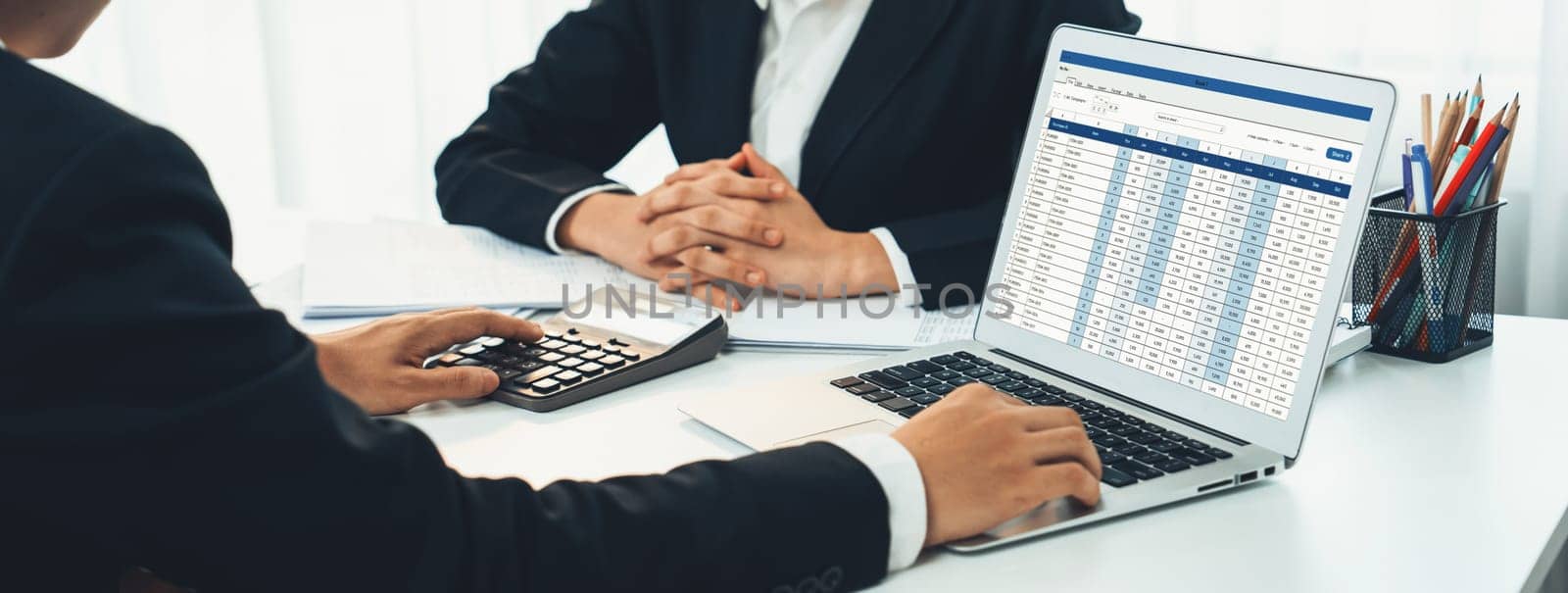 Corporate accountant team use accounting software on laptop to calculate and maximize tax refund and improve financial performance base on financial data. Modern business accounting . Shrewd