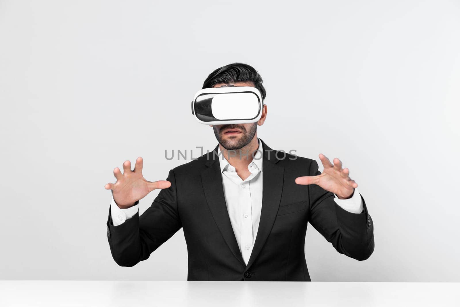 Smart businessman sitting while pointing and choosing data analysis by using technology innovation. Professional caucasian project manager using virtual reality glasses and VR goggles. Deviation.