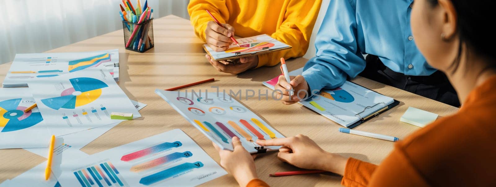 Startup company employee working together, analyzing BI dashboard paper on financial data report and planning strategic marketing for business success in panorama banner. Synergic