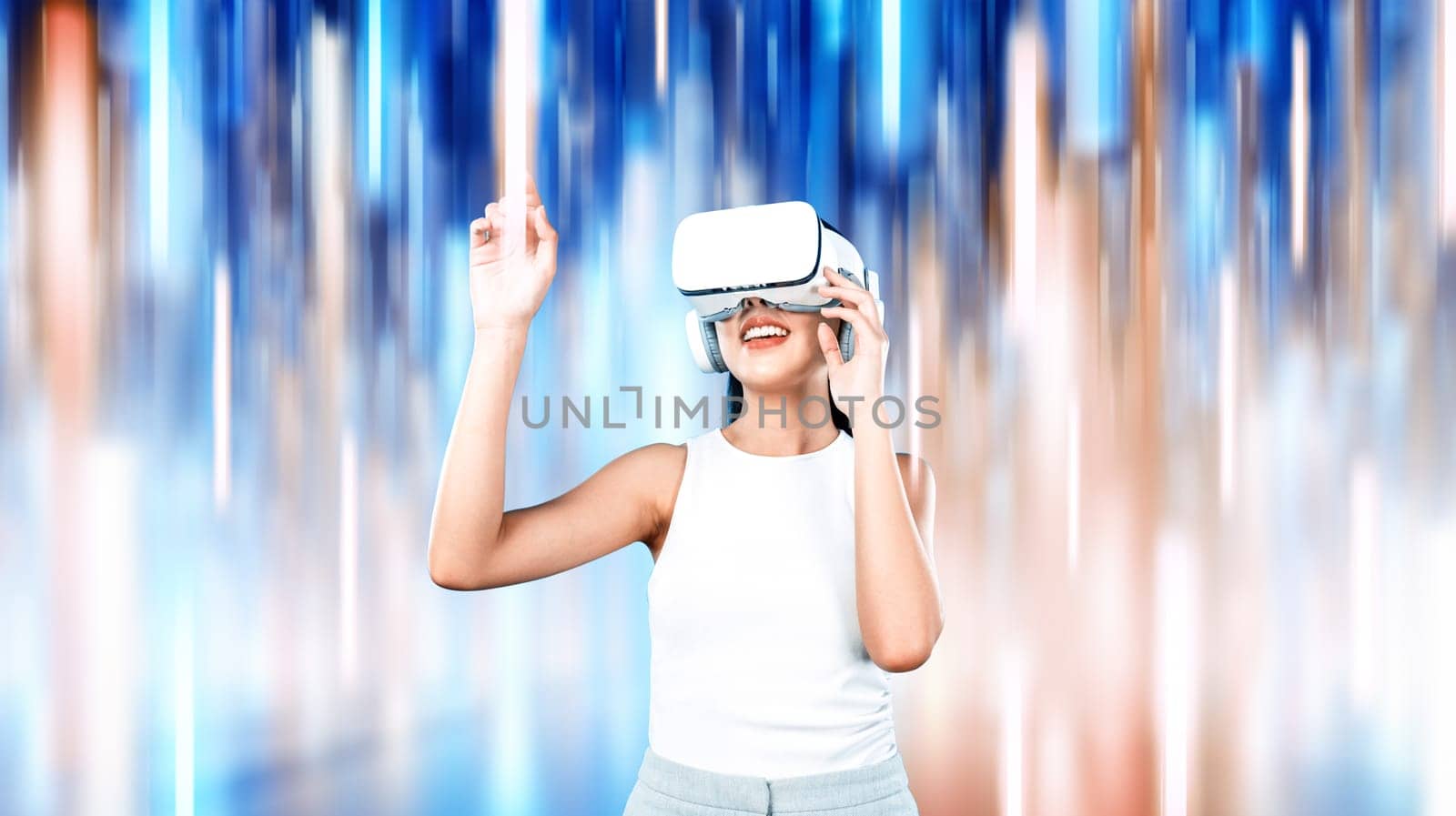 Female stand wear white VR headset and sleeveless connecting metaverse, future technology, surrounded by abstract light. She use index finger touch hologram object of virtual reality. Hallucination.