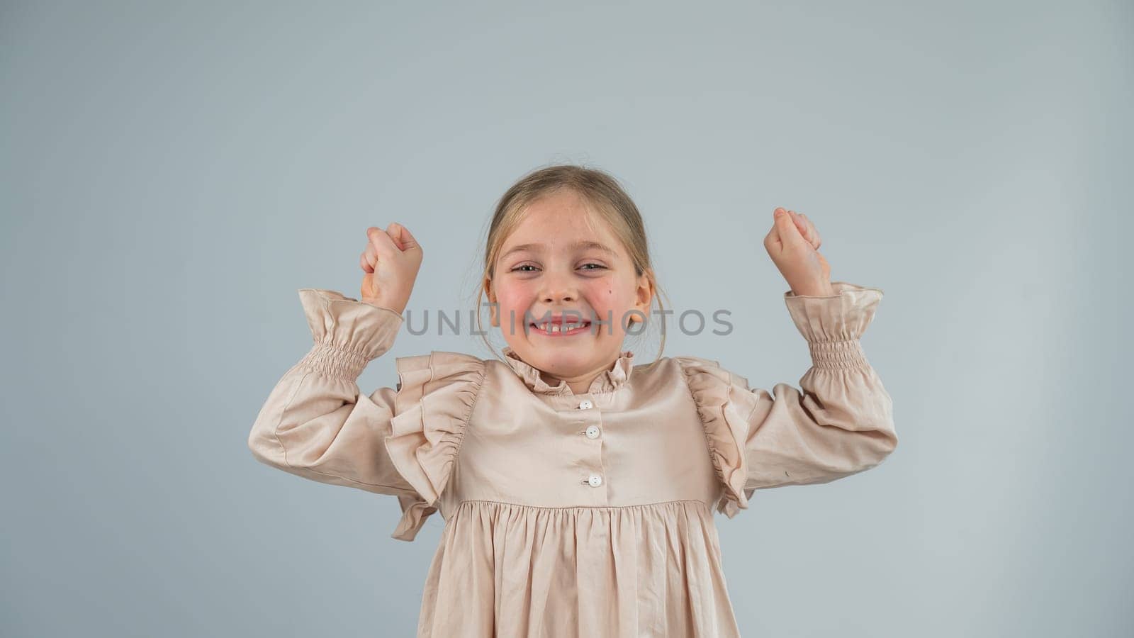 Little Caucasian girl having fun and making faces on a white background. by mrwed54