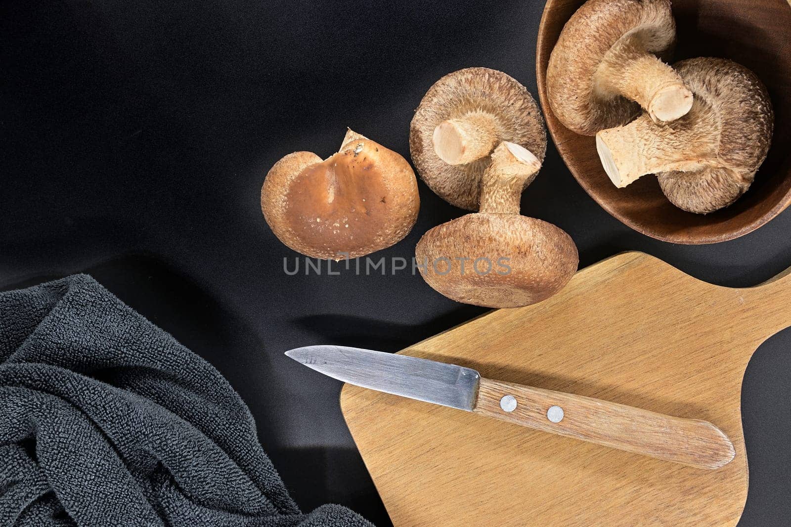 Fresh shiitake mushrooms arranged on black background by NetPix